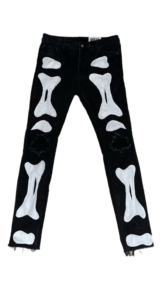 “0re0” faded black jeans with white bone print